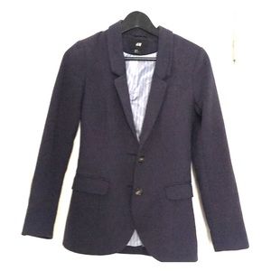 Stretchy navy blue blazer with elbow patches.
